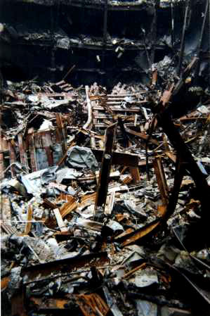 A Ground Zero Cross stands upright amid the World Trade Center destruction