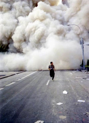 A man runs from the dust cloud after the South Tower collapses