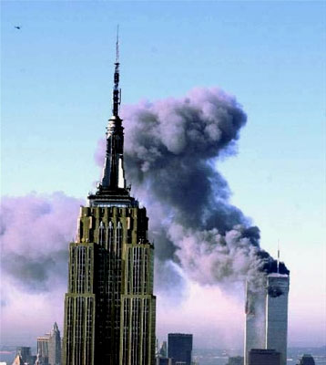 The WTC on fire; the Empire State Building is in the foreground