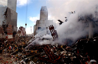 Hero firefighters spary water on ash at Ground Zero