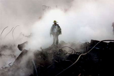 A hero firefighter walks through debris at Ground Zero