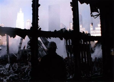 Windows of Terror: A hero rescue worker looks at Ground Zero through broken windows